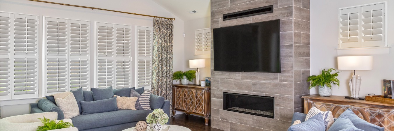 Interior shutters in Clifton Heights family room with fireplace