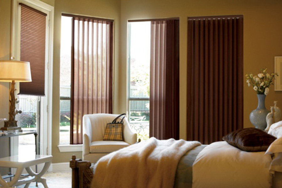 Choose durable and high-quality fabric or vinyl vertical blinds in Philadelphia. Maroon fabric vertical blinds inside a bedroom