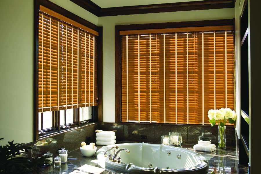 Premium quality blinds are always a stylish accent in your Philadelphia home. Brown wood blinds on large windows in a green bathroom