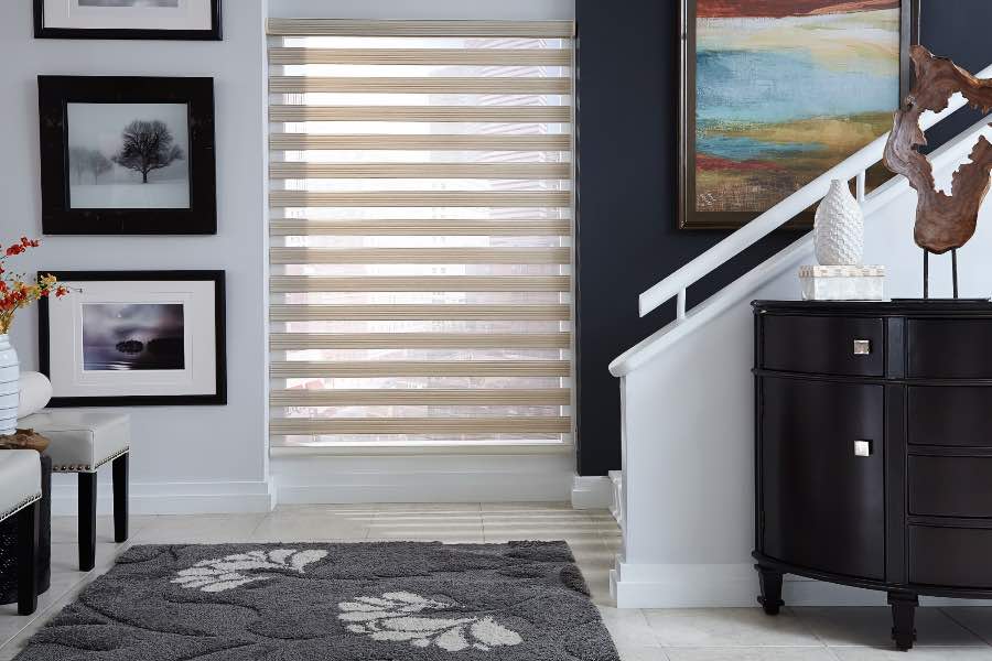Zebra shades offer exceptional light control and can be customized to match any decor. Zebra shade lets in light from a window near a staircase