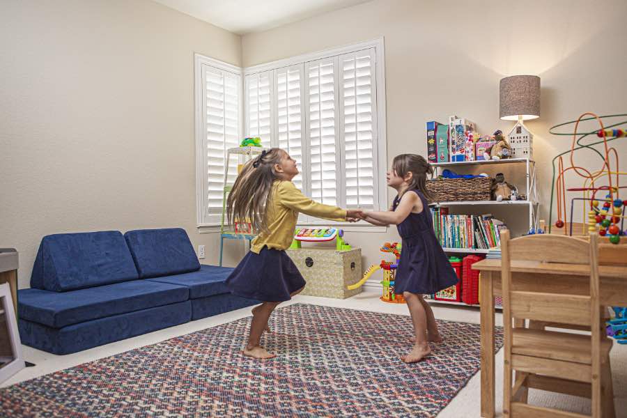 Choose Polywood shutters for durable, kid-friendly great room window treatments in Philadelphia. Polywood shutters on multiple windows in a sitting area