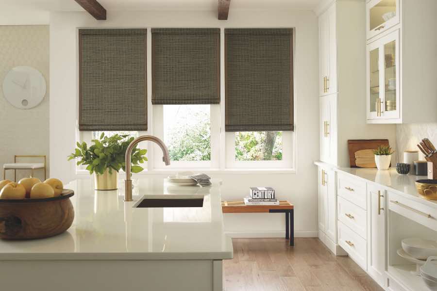 Beautiful, organic, and eco-friendly--put unique natural woven shades in your home for a special touch! Gray woven window shades on 3 windows in a kitchen