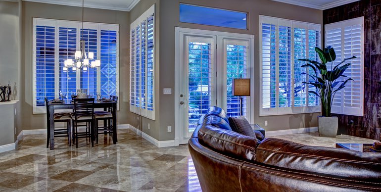 Photo Courtesy of Room Resolutions Philadelphia great room with white shutters and leather furniture.