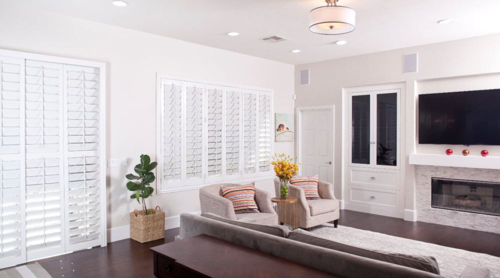 Plantation shutters are a great choice if you are looking to conserve energy. Plantation shutters in a living room