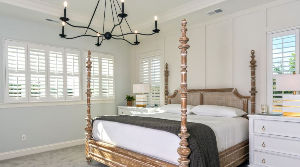Polywood® shutters are a great option when you want a clean and fresh look.  Plantation shutters in a bedroom.