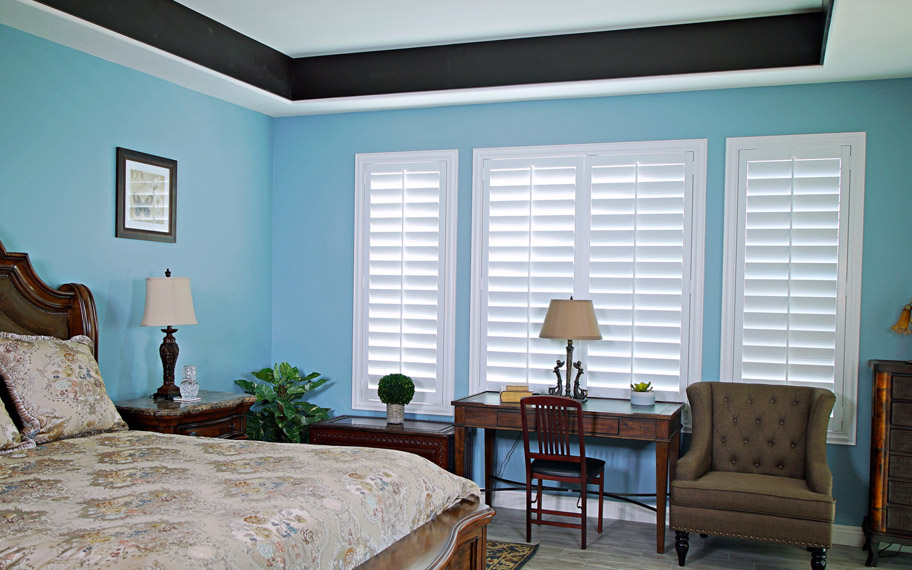 Polywood shutters provide insulation for the perfect temperature all year long in Philadelphia. Polywood shutters in a bedroom.
