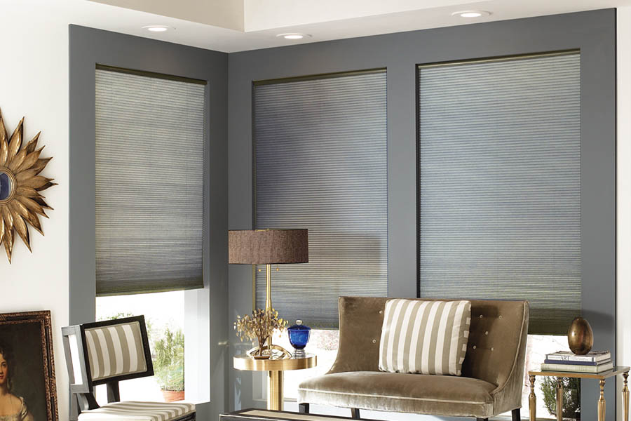 Add style and comfort to your home with cellular shades in Philadelphia. Gray cellular shades in a corner of a stylish living room.