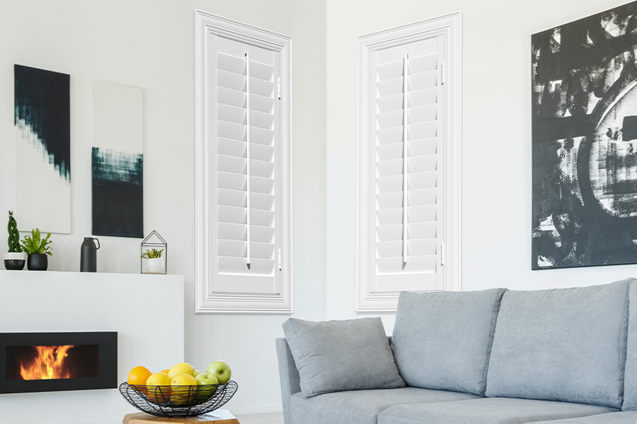 White Polywood shutters add character and class in Philadelphia. White polywood shutters in a corner of a modern living room.