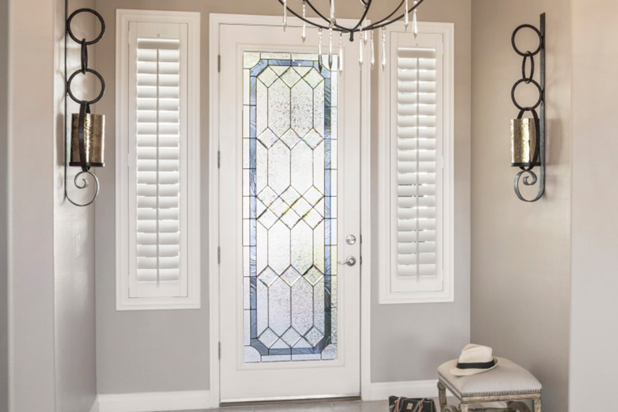 Polywood shutters offer flexibility on the brightness of natural light in Philadelphia. Sidelight windows with white polywood shutters in a foyer.