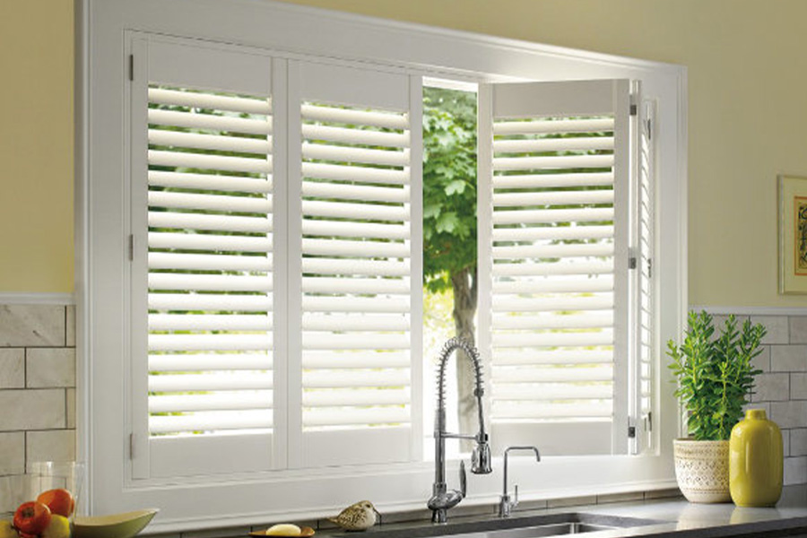 Polywood shutters are built to withstand the test of time in Philadelphia. White Polywood shutters above a kitchen sink.